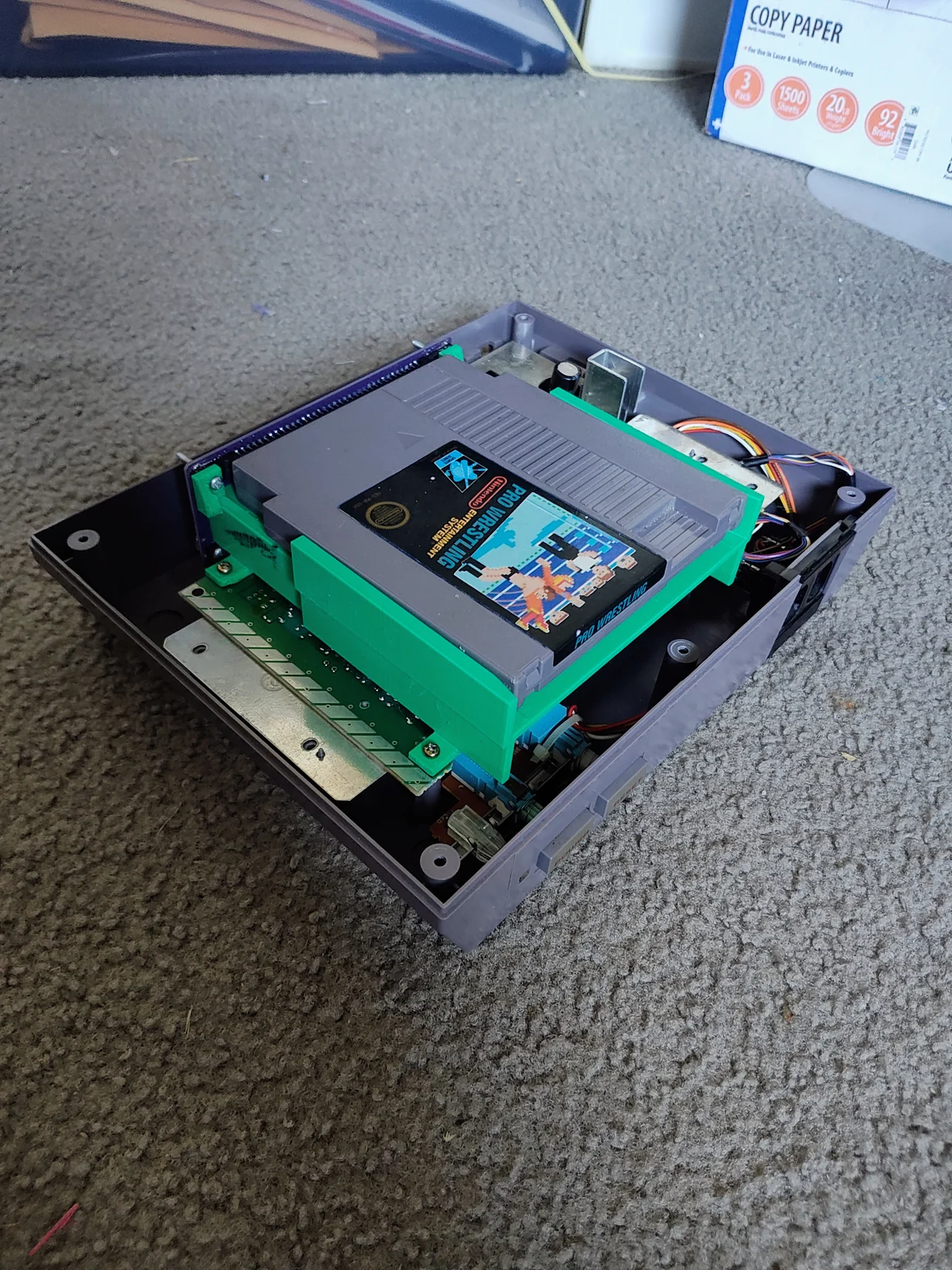 October 9, 2026 · Overhead view of the board and tray assembly with a cartridge seated in place. Final tests pending.