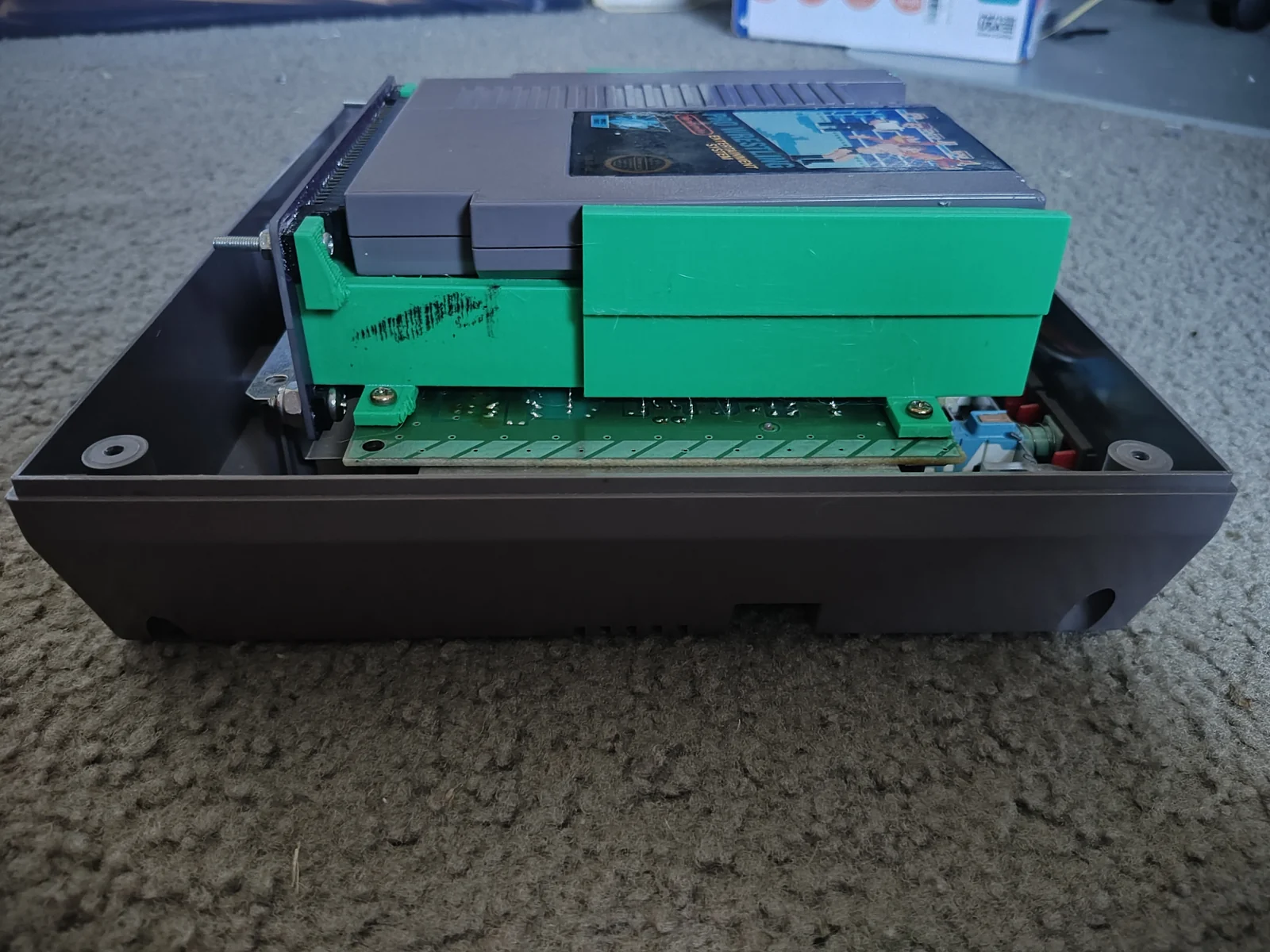 October 9, 2026 · Side view of the printed tray and its position inside the NES shell. Final tests pending.